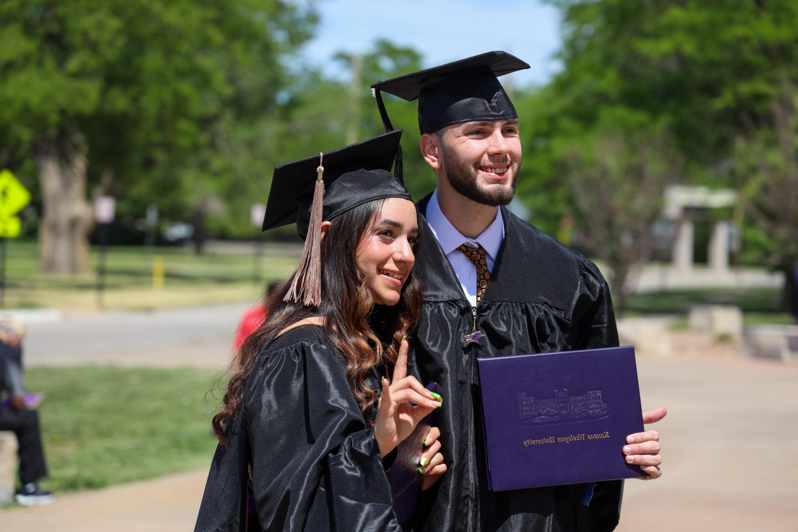 Man and woman in graduation gear
