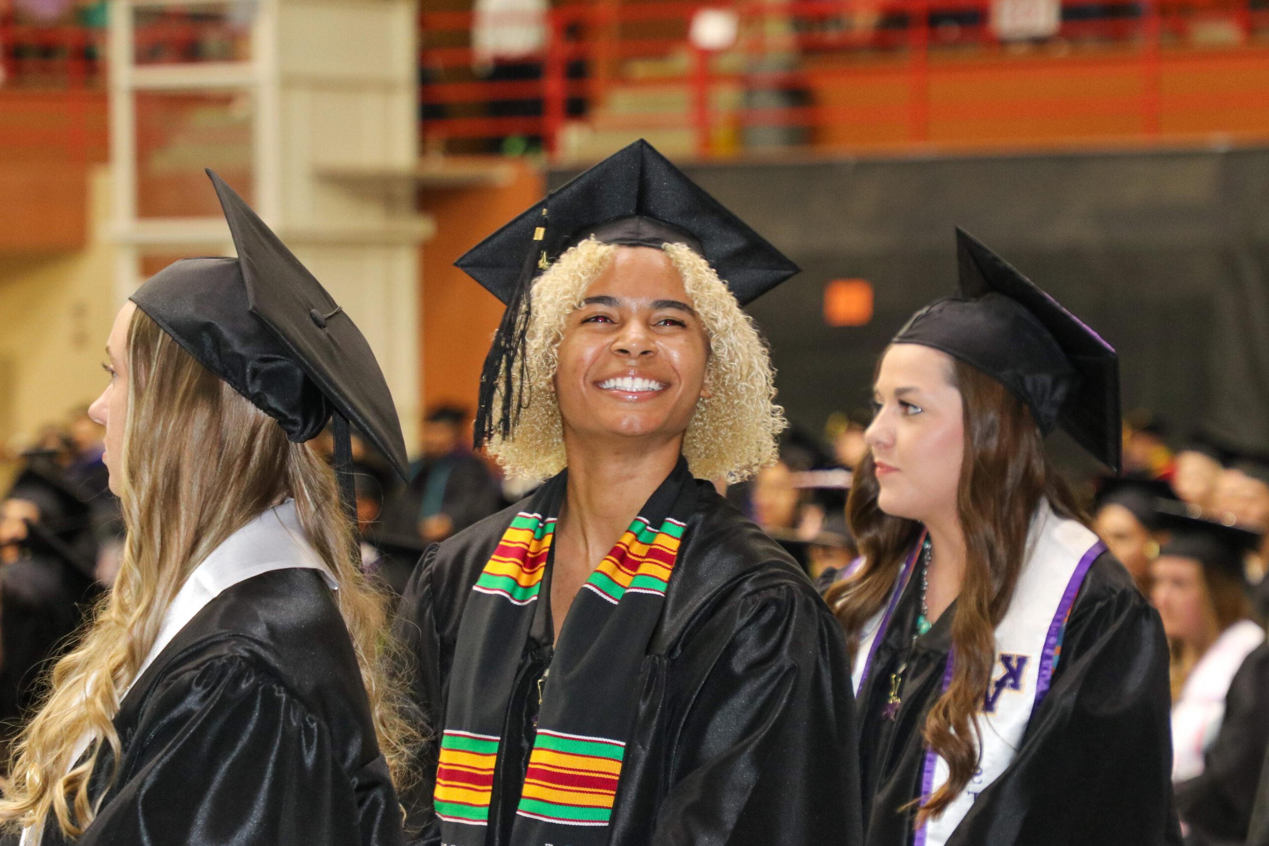 Woman in graduation attire smiling